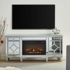 an entertainment center with a flat screen tv mounted above it and a fire place in front of the fireplace