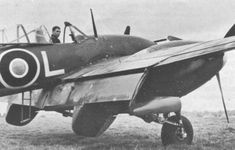 an old black and white photo of a man sitting in the cockpit of a plane