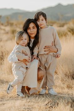 a woman and two children posing for a photo