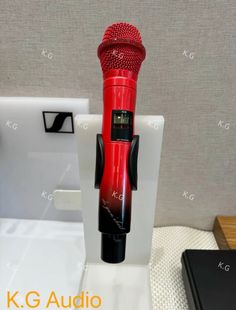 a red microphone is sitting on top of a stand