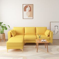 a living room with a yellow couch and coffee table