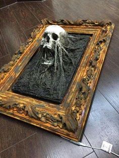 a painting on the floor with a skull in it