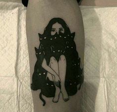 a tattoo on the leg of a woman with a cat sitting in front of her