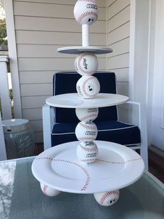 a three tiered plate with baseballs on it and the words, this is starting to look like a baseball theme