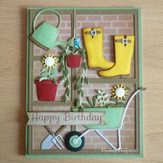 a happy birthday card with flowers and gardening items