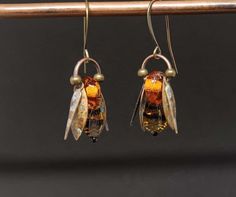 Honey Bee Earrings Amber Lampwork Dangles BeeKeeper Gift Unique Design                               * copyright Nicole Lavallee 2021 *The patina on each pair of earrings varies due to the nature of the handmade process. No two bee earrings will be exactly the same. If you would like an image sent of your unique pair, add a note to seller when you order.  Please note the dimensions. I took close-ups of the earrings to show detail which makes them appear bigger. I had so much fun creating this be Honey Bee Earrings, Beach Jewelry Boho, Bee Honey, Handmade Lampwork Bead, Polymer Crafts, Beach Boho, Bee Earrings, Honey Colour, Bee Design