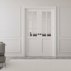 an empty room with two chairs and a door