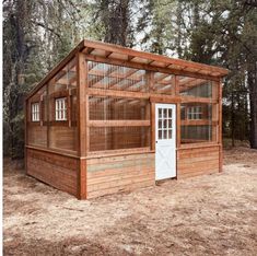 a small wooden building in the woods