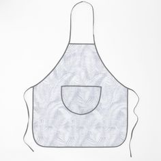 an apron with a pocket is shown on a white background, it has a pattern that resembles leaves