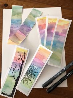 some watercolors are laying on top of paper