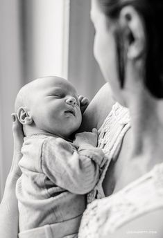 a woman holding a baby in her arms