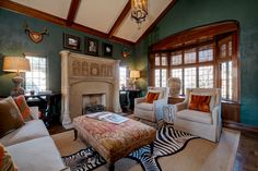 a living room filled with furniture and a fire place in the middle of a room