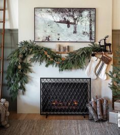 a fireplace decorated for christmas with garland and pine cones