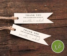 two tags that say thank you for celebrating with us and are attached to twine