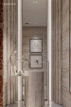 a room with marble walls and flooring in the center is filled with vases