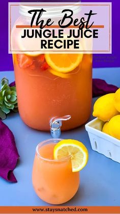 a jar filled with orange juice next to some lemons