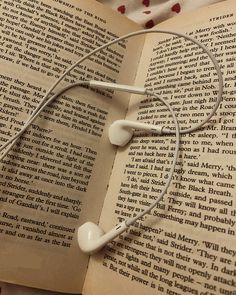 an open book with headphones on top of it