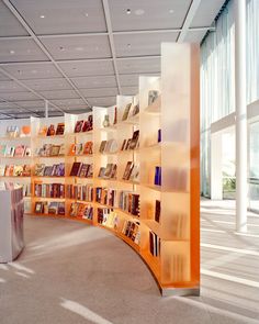 a curved bookshelf filled with lots of books