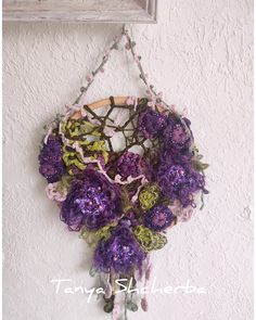 purple flowers are hanging on the wall