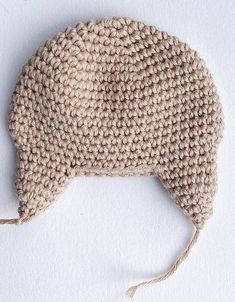 a knitted hat is shown on a white surface