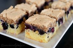 several pieces of blueberry cake on a white plate