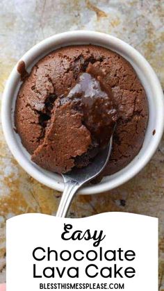 a hand holding a spoon full of chocolate ice cream