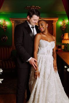 a man and woman in formal wear standing next to each other