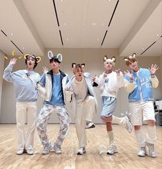 five young men in bunny ears are posing for a photo on the dancefloor