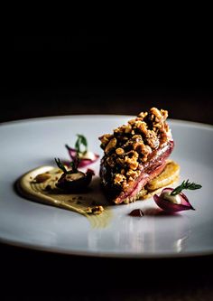 a white plate topped with food on top of a wooden table