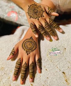 two hands with henna tattoos on them