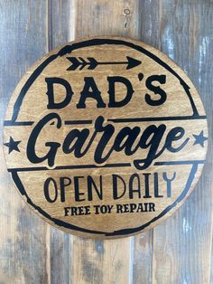 a wooden sign that says dad's garage open daily