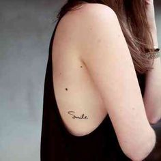 a woman with a small tattoo on her shoulder