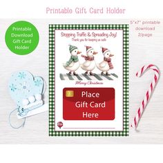 a christmas gift card with two birds on it and candy canes next to it