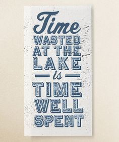 a red and white sign that says time wasted at the lake is time well spent