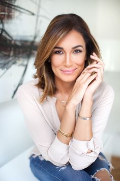 a woman sitting on top of a white couch