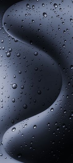 drops of water on the surface of a black background