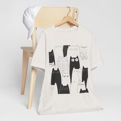 Celebrate the charm of simplicity with our Minimalist Black and White Cat T-Shirt. This tee features a whimsical and adorable kitty illustration, perfect for cat lovers who appreciate modern and minimalistic designs. Made from soft, breathable fabric, this unisex t-shirt is great for casual outings or cozy days at home. Its playful yet understated design adds a touch of fun to your wardrobe, making it an ideal gift for animal lovers or a treat for yourself. Available in various sizes to fit your style. This classic unisex jersey short sleeve tee fits like a well-loved favorite. Soft cotton and quality print make users fall in love with it over and over again. These t-shirts have-ribbed knit collars to bolster shaping. The shoulders are tapered for a better fit over time. Dual side seams ho Kitty Illustration, Minimalist Black And White, Black And White Cat, Cat T Shirt, Black & White, Animal Lovers, Cat Tshirt, White Cat, Leisure Wear