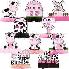 a cow birthday cake topper with farm animals