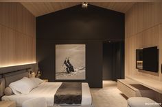 a bed room with a neatly made bed and a painting on the wall