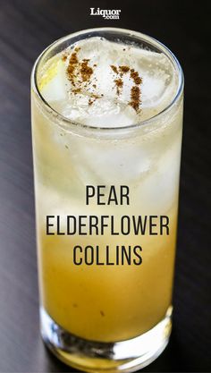 a tall glass filled with ice and some type of drink on top of a table