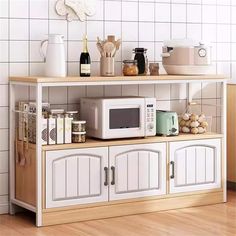 a white microwave oven sitting on top of a wooden shelf