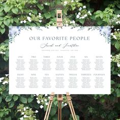 an easel with a sign on it that says our favorite people and is surrounded by greenery