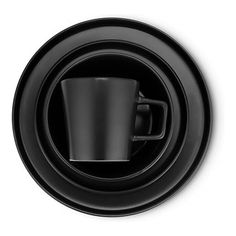 a black cup and saucer sitting on top of each other