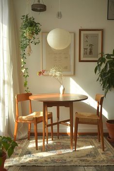 a table and chairs in a room with potted plants