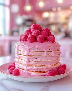 a pink cake with raspberries on top