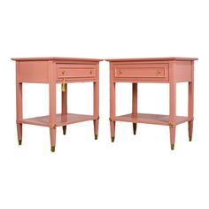 pair of pink nightstands with gold handles on each side and one drawer at the top