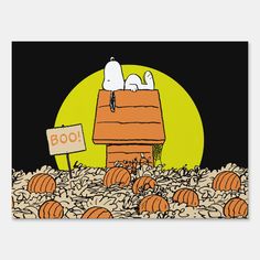 a snoopy halloween scene with pumpkins on the ground and a sign that says happy halloween