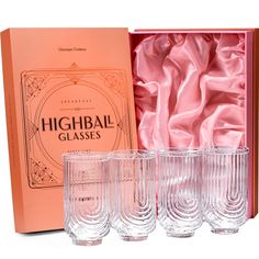 four glasses in a pink box next to an orange case with the words highball glasses written on it