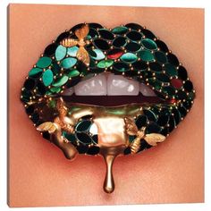 a woman's lips with gold and green decorations on them