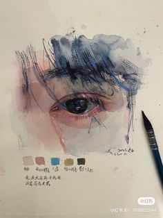 a drawing of an eye with watercolors on it and a pen next to it